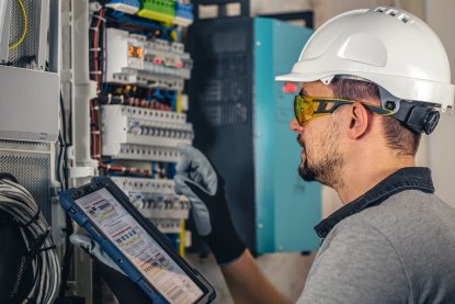 man-electrical-technician-working-switchboard-with-fuses.jpg